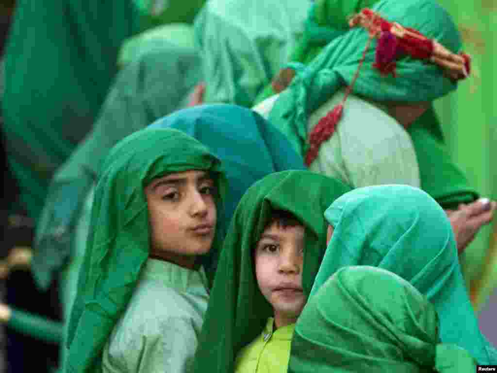 Children taking part in a religious passion play walk in the streets of Tehran during Ashura on December 15. Shi'a all over the world mourn the slaying of Imam Hussein during the first 10 days of the Islamic month of Muharram. Photo by Caren Firouz for Reuters