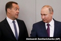 Russian President Vladimir Putin (right) and Prime Minister Dmitry Medvedev at the State Duma on May 8.