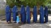 Afghan women voters line up to cast their ballots in Jalalabad on June 14 in the second round of a presidential election that has been marred by fraud allegations.