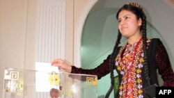 A woman casts her ballot at a polling station in Ashgabat.