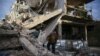 A person inspects damaged building in the besieged town of Douma, Eastern Ghouta, Damascus, Syria February 20, 2018.