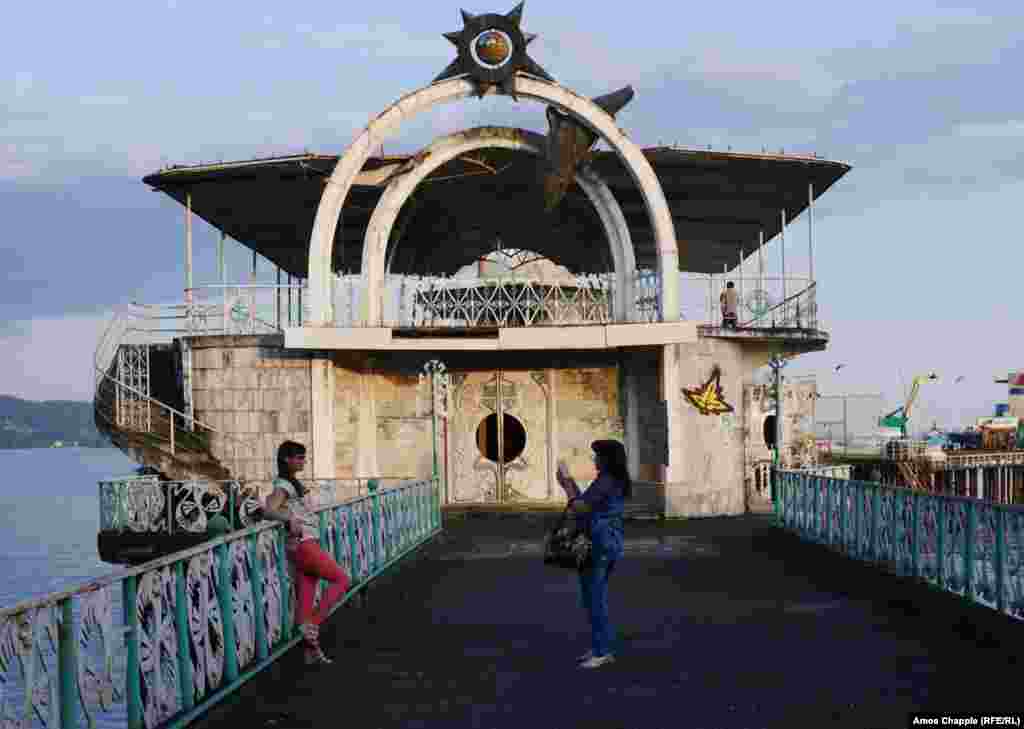 Tourists taking photographs on the waterfront of Sukhumi. 