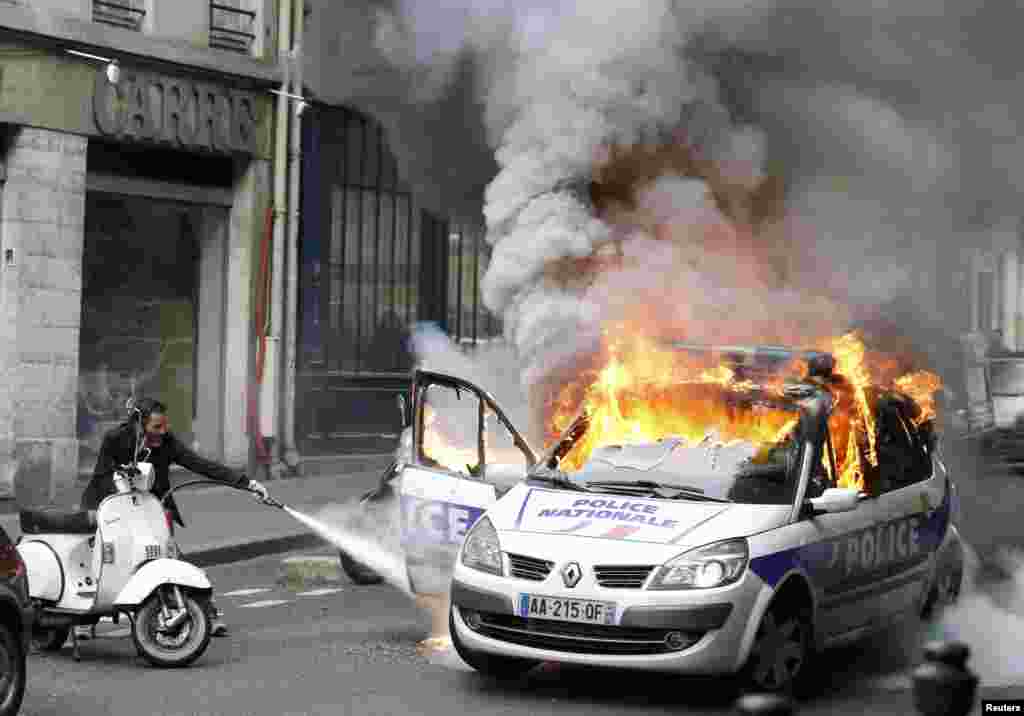 A police car burns during a demonstration against police violence and French labor reform in Paris on May 18. (Reuters/Charles Platiau)