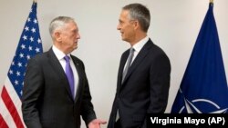 U.S. Secretary for Defense Jim Mattis (L) speaks with NATO Secretary General Jens Stoltenberg prior to a meeting on the sidelines of a NATO defense ministers meeting at NATO headquarters in Brussels on November 8.