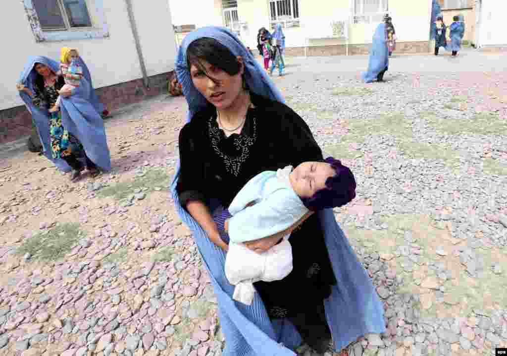 Afghan women wait to get medical treatment at the refugee camp in Herat. The camp provides refugees with basic medical treatment, education, food, and hygiene. (epa/Jalil Rezayee)