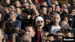 Demonstrators shout antigovernment slogans during a protest in Pristina on February 17. 