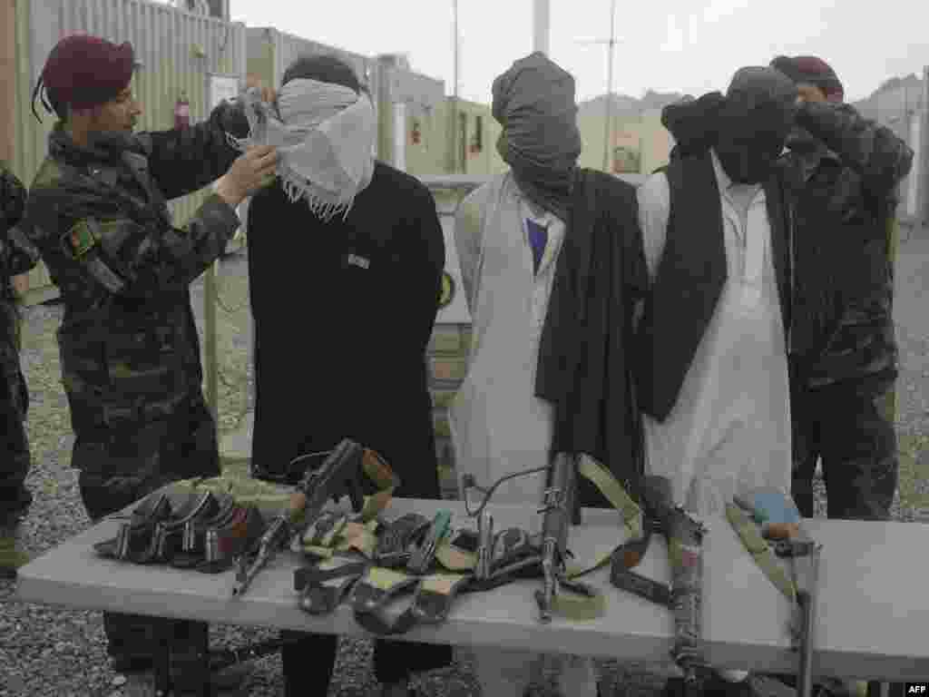 Афганские силовики представители журналистам захваченных в плен боевиков движения Талибан в провинции Герат. 