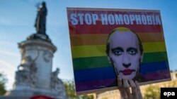 A demonstrator holders a placard depicting Russian President Vladimir Putin at a rally in Paris on April 20 to denounce the treatment of homosexuals in Chechnya.