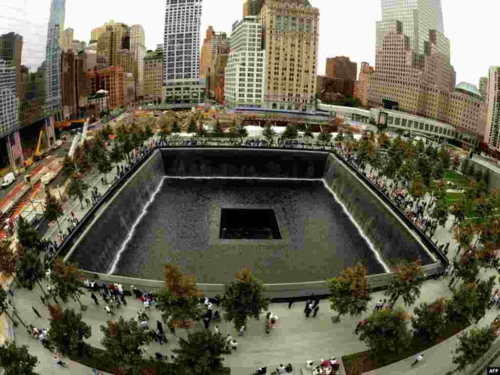Families line up against the wall of the South Memorial pool during 10th anniversary ceremonies at the site of the World Trade Center in New York.