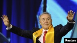 Kazakh President Nursultan Nazarbaev greets supporters during a forum titled "Forward, Together With The Leader" in Astana on April 4.