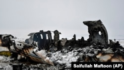 FILE: The wreckage of a U.S. military aircraft that crashed in the central Afghan province of Ghazni on January 27.