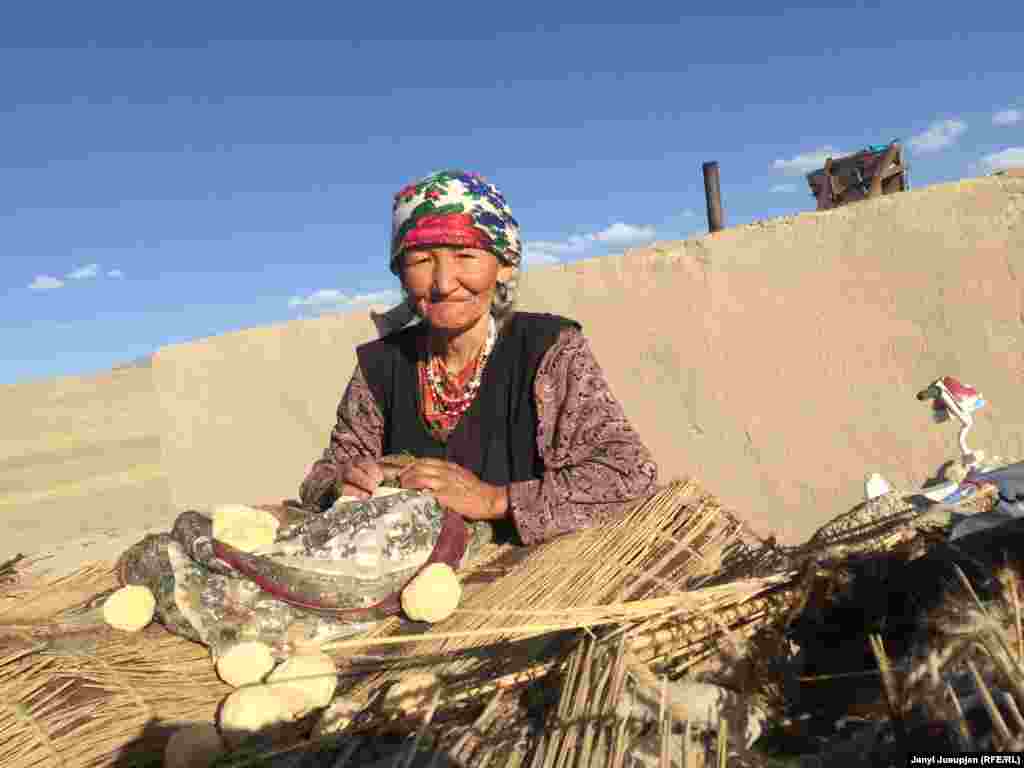 Zilal collecting kurut, dried yogurt cheese made of yak milk. In winter it is dissolved in water and consumed with broth.