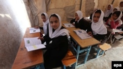 Afghanistan -- Afghan school girls attend a class at a makeshift camp in Herat, April 2, 2015.