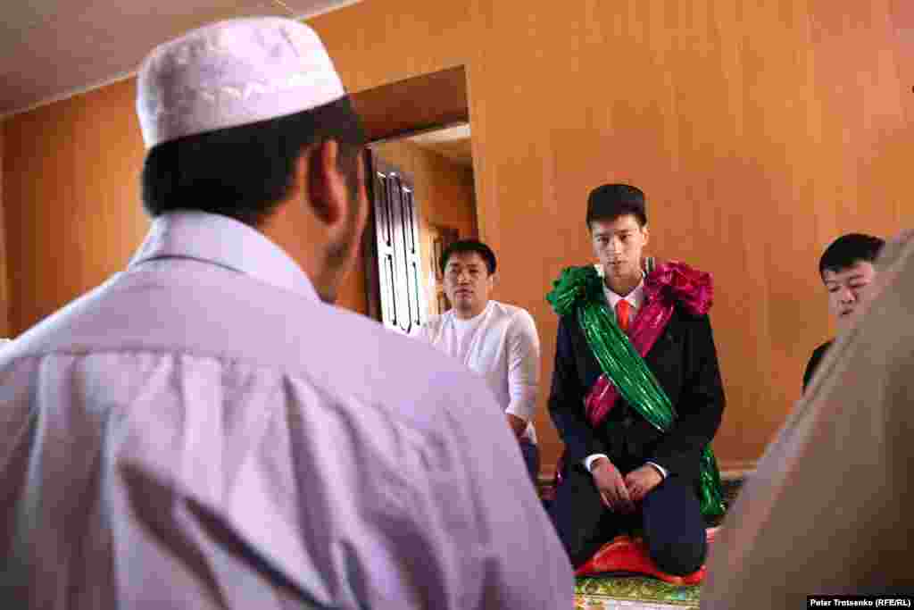 At the house of the bride, a mullah holds the nikah, or Islamic marriage ceremony.