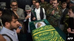 Relatives and friends gather around the coffin of Afghan reporter Zabihullah Tamanna, who was killed in a Taliban ambush in June 2016.