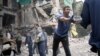 Rescue workers and local residents remove debris of an apartment building near Donetsk hit by an air strike. The war-torn Donetsk region's self-styled leaders say the situation there is now "extremely serious." 