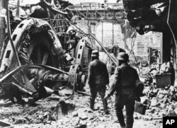 German troops pass through a wrecked generating station in the factory district of Stalingrad on December 28, 1942.