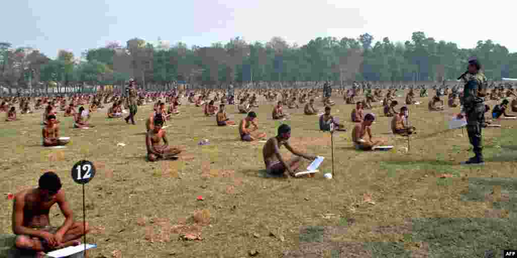 Indian Army candidates sit in their underwear to deter cheating as they take a written exam during a recruitment day in Muzaffarpur. (AFP)