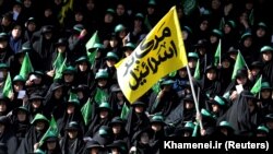 Female regime supporters are seen at Azadi stadium during the speech of the Iranian Supreme Leader Ayatollah Ali Khamenei in Tehran. The yellow banner says "Death to Israel". October 4, 2018.