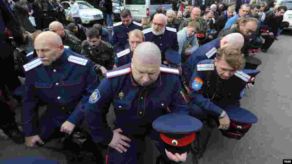 Cossacks block the entrance of the Winzavod art gallery in Moscow on October 2 to protest an exhibition of works inspired by activist punk performance group Pussy Riot. (ITAR-TASS)