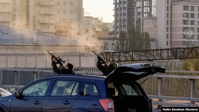 Ukrainian police shoot at a suicide drone in Kyiv on October 17.