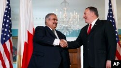 Secretary of State Mike Pompeo, right, shakes hands with Bahrain Foreign Minister Khalid bin Ahmed Al Khalifa, Wednesday, July 17, 2019, during their meeting at the State Department in Washington. (AP Photo/Jacquelyn Martin)