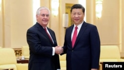 Chinese President Xi Jinping (right) shakes hands with U.S. Secretary of State Rex Tillerson in Beijing on March 19.