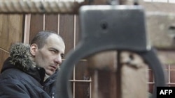 Vasily Aleksanian in the defendant's cage of a Moscow court in February