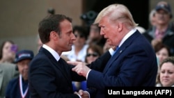 U.S. President Donald Trump (right) talks with French President Emmanuel Macron in June