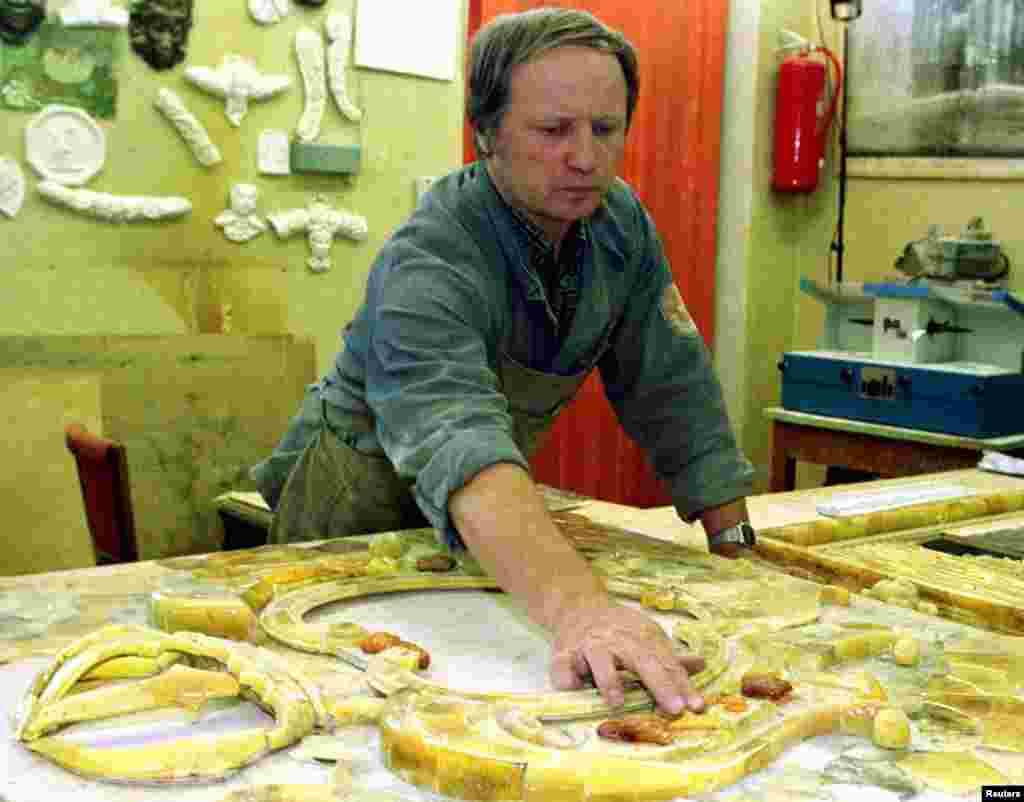 After the disappearance of the treasure during World War II, Soviet authorities commissioned a team of craftsmen, including Vyacheslav Kurakin (pictured), to reconstruct the Amber Room within the Catherine Palace.