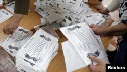 Ukraine -- Members of a local election commission sort ballot after all ballots were taken from a ballot box as the commission start counting votes of "referendum" on the status of Luhansk, May 11, 2014