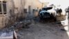 Iraqi policemen inspect the damage inside a police station in Samarra city on January 3.