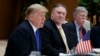 U.S. Secretary of State Mike Pompeo, center, and national security adviser John Bolton, right, listen as U.S. President Donald Trump speaks during a meeting with Vietnamese Prime Minister, in Hanoi, February 27, 2019 