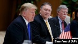 U.S. Secretary of State Mike Pompeo, center, and national security adviser John Bolton, right, listen as U.S. President Donald Trump speaks during a meeting with Vietnamese Prime Minister, in Hanoi, February 27, 2019 