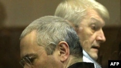 Mikhail Khodorkovsky, left, and his former business partner and co-accused Platon Lebedev. A Russian Ombudsman acknowledges that politics is at the root of Khodorkovsky's case. 