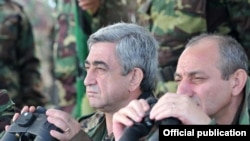 Armenia -- President Serzh Sarkisian (L) watches military exercises in Nagorno-Karabakh on October 22, 2009.