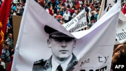 Ethnic Albanians hold portraits of former Kosovar Liberation Army commander Sylejman Selimi during a protest in Pristina in June 2015.