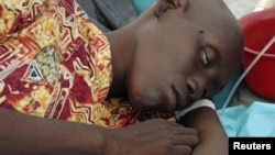 A Haitian resident suffering from cholera waits for medical treatment 