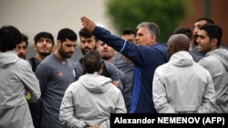 Iran's Portuguese soccer coach, Carlos Queiroz, gestures as he talks to his team.