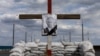 UKRAINE – A portrait of Russian President Vladimir Putin in a cross depicting his tomb is seen at a checkpoint outside Dnipro amid Russia's invasion in Ukraine, May 10, 2022