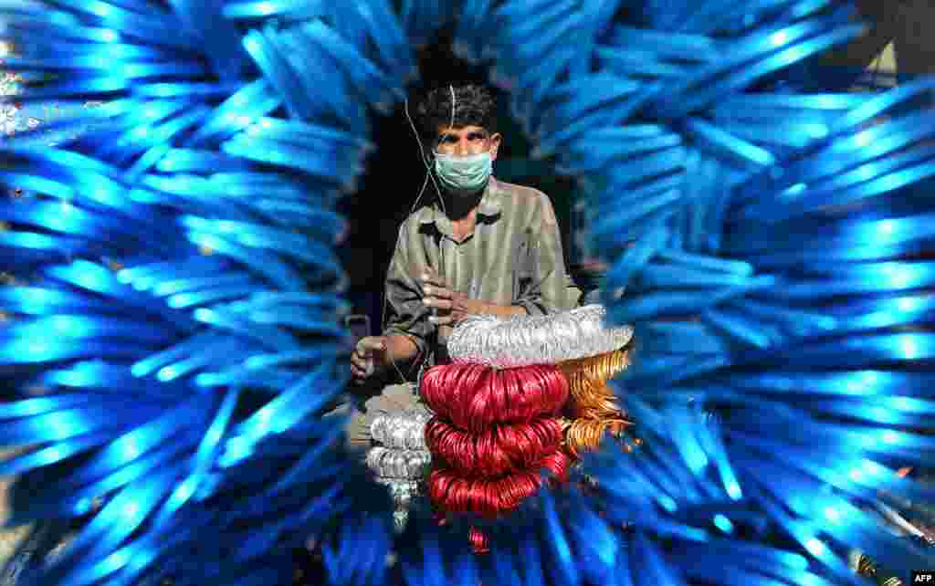 A vendor arranges bangles at his shop in Lahore, Pakistan. (AFP/Arif Ali)