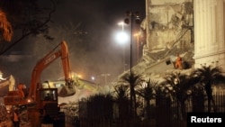 Rescue workers search the debris of collapsed buildings in Rio de Janeiro.