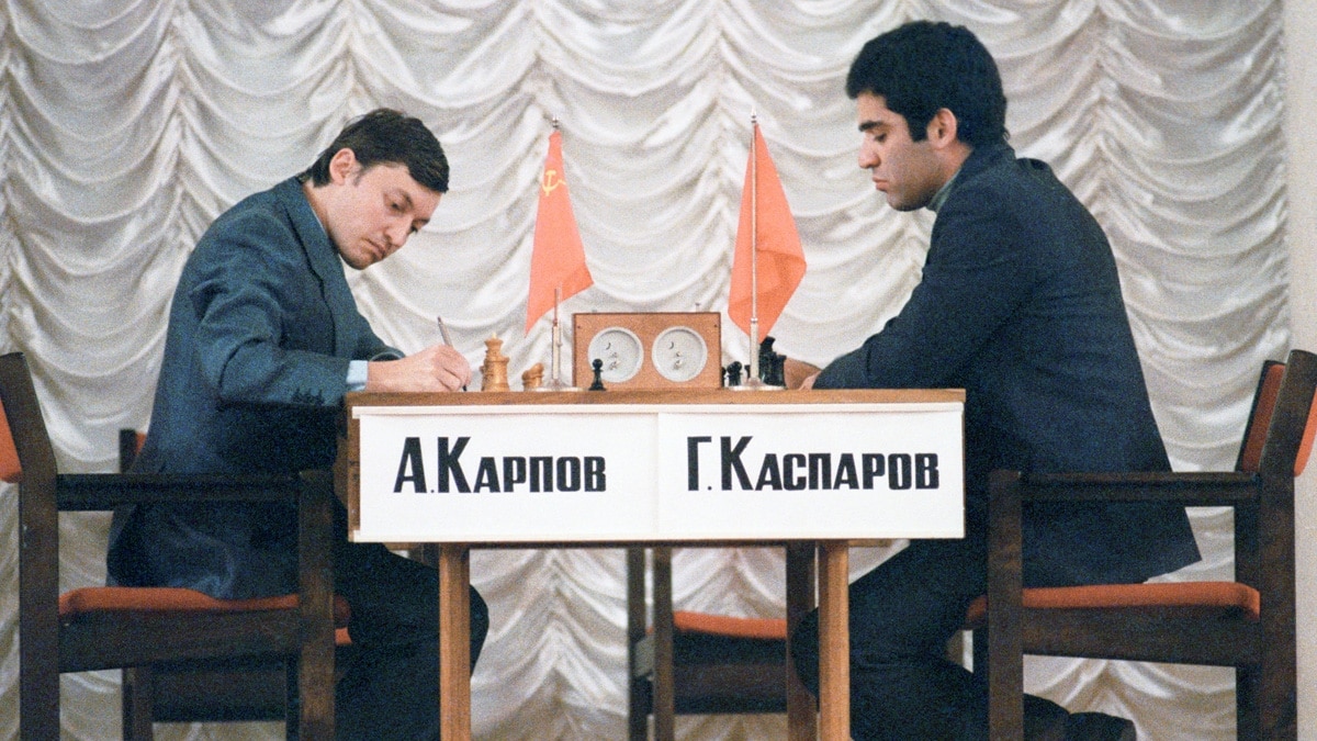 FIDE presidential candidate and former World Chess Champion, Anatoly  Karpov, lower, reacts as former World Chess Champion, Garry Kasparov walks  pass before the start of their World Chess Federation (FIDE) presidential  election