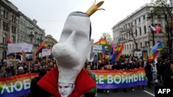 Members and supporters of the LGBT community carry a caricature bust of Russia's President Vladimir Putin as they parade in St. Petersburg in May 2014.