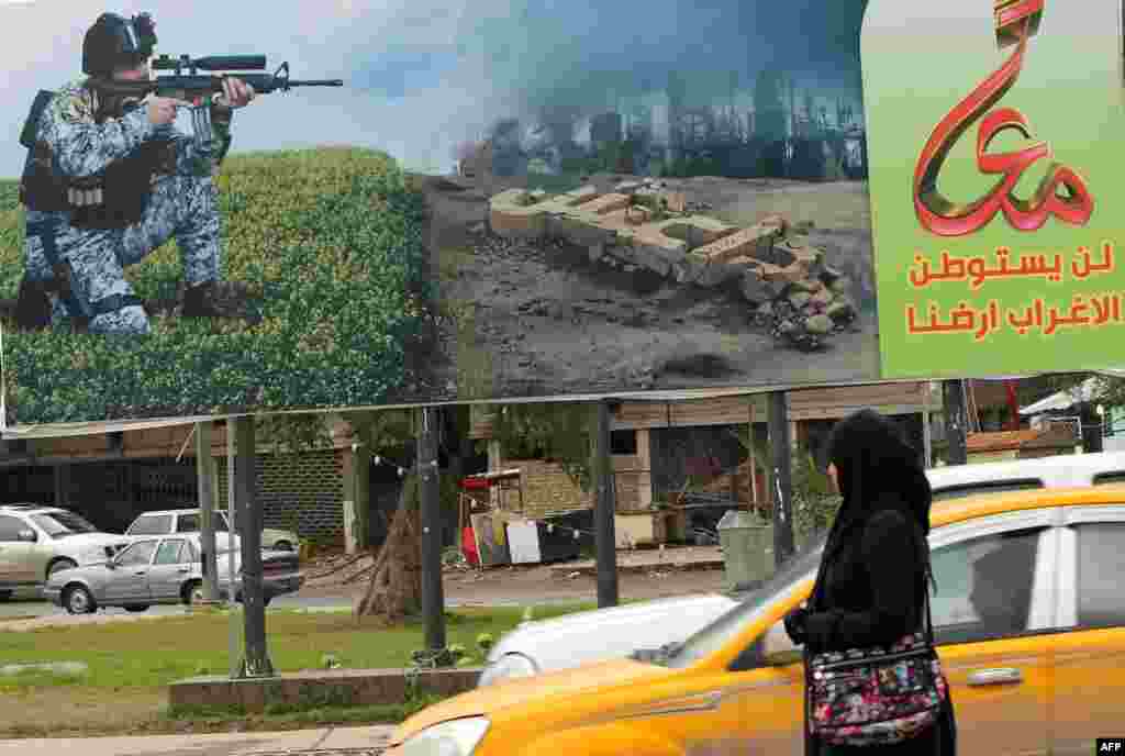 In Baghdad, a billboard depicting a member of the Iraqi security forces aiming his weapon against unseen militants.