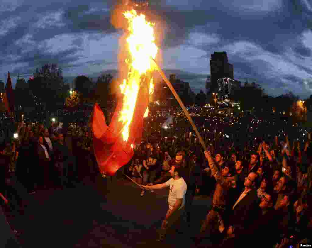 Armenian demonstrators in Yerevan set fire to a Turkish flag during a march marking the anniversary of the 1915 mass killings of Armenians in the Ottoman Empire on April 23. (Hayk Baghdasaryan, Photolure)