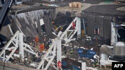 Rescuers search for survivors at the site where the Maxima supermarket roof collapsed in Riga, leaving dozens dead. 