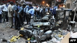 Police and investigators at the site of a deadly bomb blast in Hyderabad on February 21.