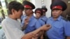 A demonstrator argues with police officers in front of the Belarusian Embassy in Bishkek, Kyrgyzstan in 2012.