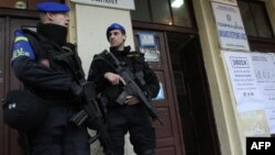 EULEX policemen secure the entrance of a polling station in the Serb-populated part of the ethnically divided town of Kosovska Mitrovica during elections in November 2013.